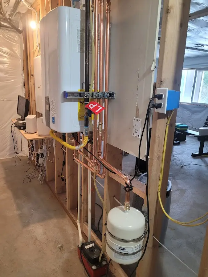 Licensed plumber repairing a kitchen sink in Harrah